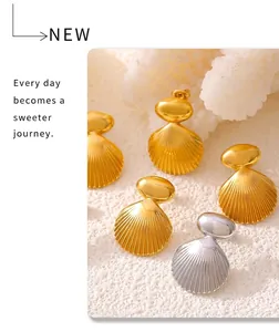 Macro view of geometric shell stud earrings in 18k gold and silver plated finish