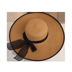 Women's wide brim straw sun hat with black ribbon bow for summer beach vacation