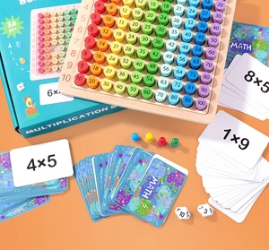Close-up of wooden multiplication board set with colorful cylinders and math cards
