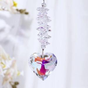 Macro detail of heart-shaped crystal suncatcher pendant with rainbow light reflections