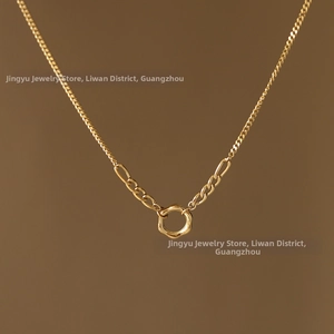Detail of minimalist 18K gold plated chain necklace with irregular round pendant