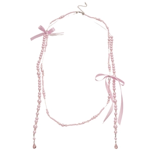 French style bow pearl necklace with pink ribbons and teardrop pendants on white background