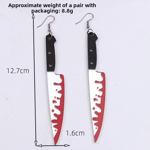Detail of acrylic bloody knife earrings showing silver blade with red blood drips