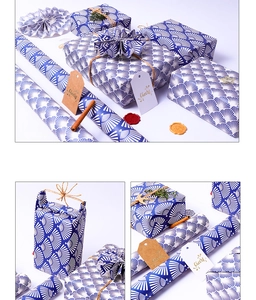 Blue gift wrapping paper with white fan patterns, hemp rope, and Cheers gift tags