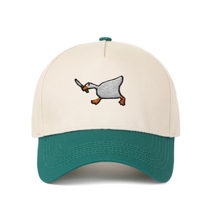 Detail of goose with knife embroidery on a beige and green color block baseball cap