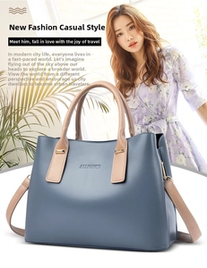 Detail of blue tote bag showing contrasting handles and golden hardware