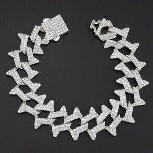 Close-up of a silver-toned iced-out Cuban link bracelet with sparkling rhinestones