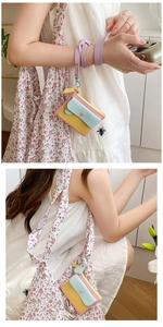 Detailed shot of macaron patchwork coin purse with wrist strap and metal clasp