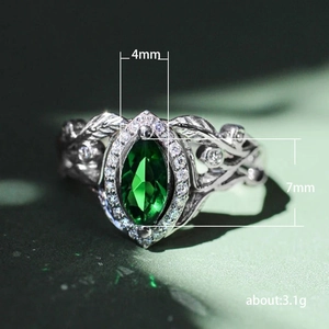 Vintage silver ring with marquise-cut green zircon and leaf-shaped diamond accents