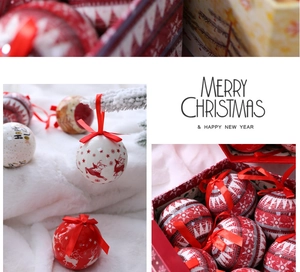 Close-up of red and white Christmas baubles with reindeer patterns and ribbons