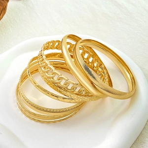9-piece gold textured bracelet set with minimalist, woven, and geometric designs