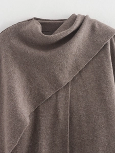 Detail of brown knit coat featuring asymmetric cowl neck and textured fabric detail