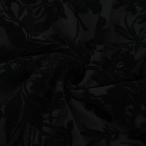 Macro view of black flocked lace fabric with floral patterns and sheer mesh texture