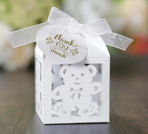 Detailed laser-cut white bear gift box with organza ribbon and thank you tag on wood surface