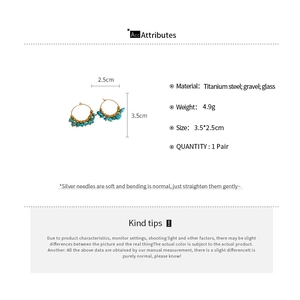 Detailed view of Bohemian gold hoops with blue stones and product specifications