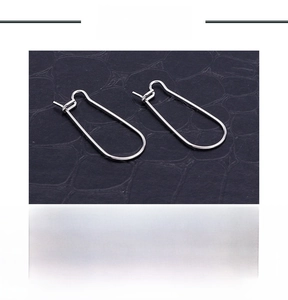Detailed view of U-shaped stainless steel earring hooks for jewelry making on leather