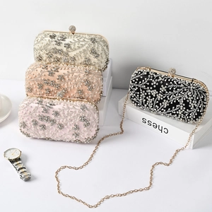 Detailed display of beaded evening bags in champagne, pink and black with crystal floral patterns