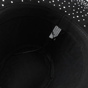 Macro view of inner polyester lining and silver rhinestone detailing on a black fedora