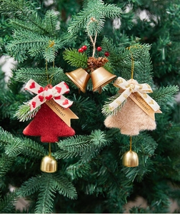 Detailed view of red and beige felt Christmas tree ornaments with golden bells and berries