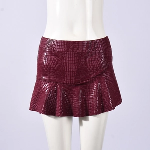 Detailed texture of burgundy crocodile embossed leather on high waist ruffle mini skirt