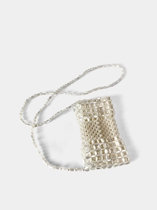 Close-up of white handmade beaded crossbody bag with a delicate woven pearl strap