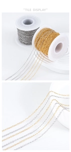 Macro view of gold and silver plated stainless steel O-chains on white spools for DIY jewelry