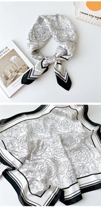 Elegant silk scarf detail with black and white peony floral print and smooth satin texture