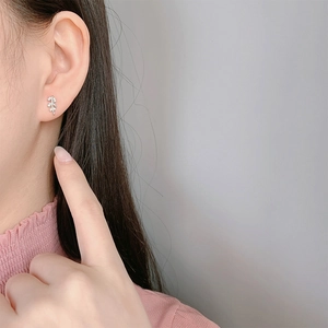 Minimalist S925 sterling silver leaf stud earrings with zircon stones on model ear