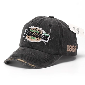 Close-up of distressed baseball cap with 3D letter embroidery and vintage worn edges