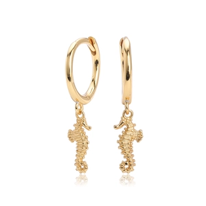 Detailed close-up of a golden seahorse charm hanging from a polished earring hoop