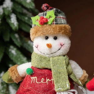 Christmas snowman plush decoration with Merry embroidery and knitted scarf on festive backdrop