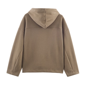 Detail of soft brown oversized hoodie featuring a large hood and dropped shoulder design