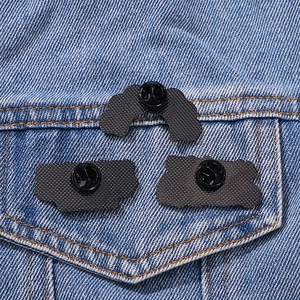 Three Lion King cartoon pins shown from the back on a blue denim jacket pocket