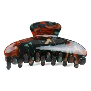 Close-up of gloss acetate shark hair claw with dark tortoise shell amber patterns
