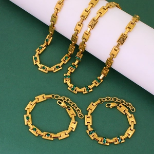 Elegant gold chunky link chain necklace and bracelet set with green crystal accents