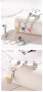 Detail shot of heart-shaped opal earrings with zircon accents on a white display stand