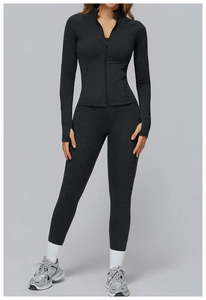 Detail of high-waist yoga leggings and zip-up jacket in heathered dark grey performance fabric