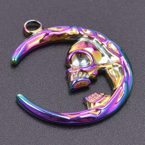 Macro detail of rainbow stainless steel crescent moon pendant with skull motif