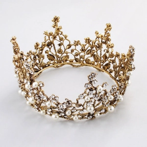 Detailed macro view of vintage gold bridal crown with crystals and white pearls