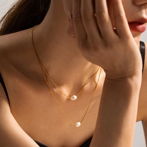 Elegant gold double-layered titanium steel necklace with irregular baroque pearl pendants
