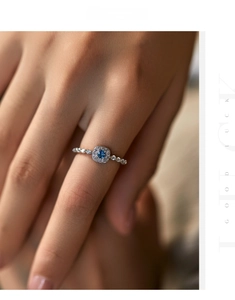Close-up of a s925 silver ring featuring a square blue gem worn on a hand