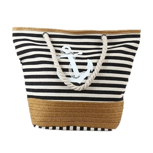 Fashionable black and white striped canvas beach bag with anchor print and tassel details