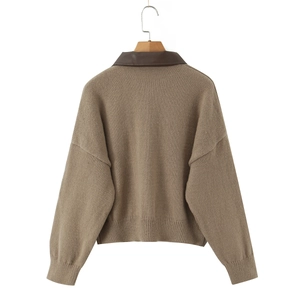 Detail view of camel knit cardigan with dark brown leather collar stitching on the back