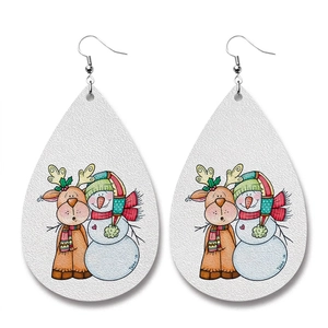 Close-up of teardrop faux leather earrings featuring reindeer and snowman holiday print