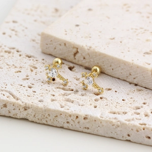 Macro shot of gold cross stud earring with heart cubic zirconia and screw back design