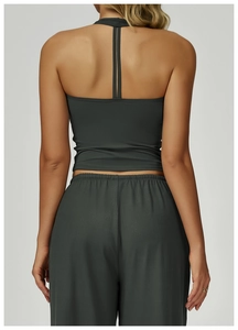 Detail of cross-back yoga tank top and high-waisted wide-leg pants in deep grey-green