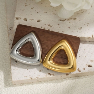 Polished hollow triangle stud earrings in gold and silver finish on elegant stone display