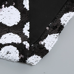 Macro view of black and white polka dot sequins on luxury high-quality fabric
