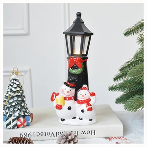 Ceramic Christmas snowman lamp post ornament with warm LED light for holiday tabletop decor