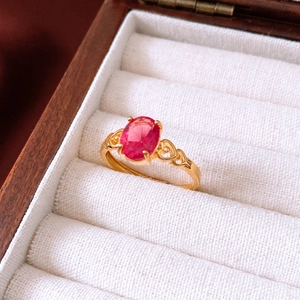 Makroaufnahme: Vintage-Ring in Gold mit rotem Oval-Edelstein und Herz-Ausschnitten